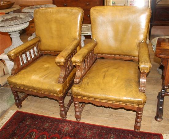 A pair of Victorian oak library chairs, upholstered in brown leather, W.68cm D.76cm H.102cm